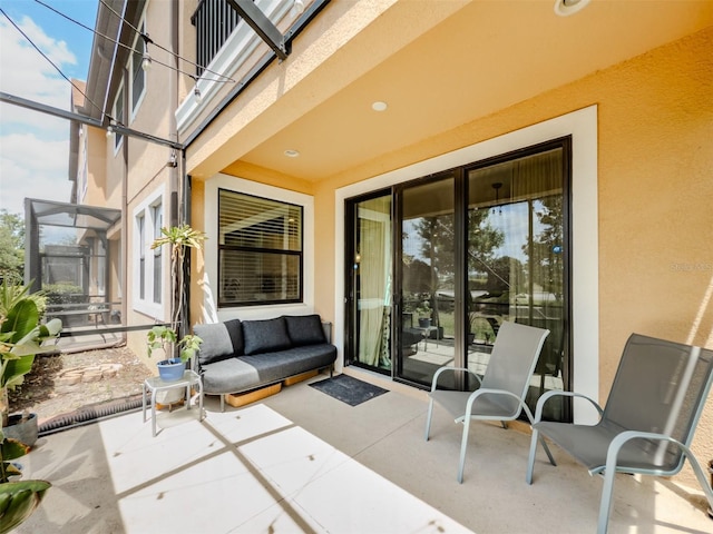 view of patio with glass enclosure