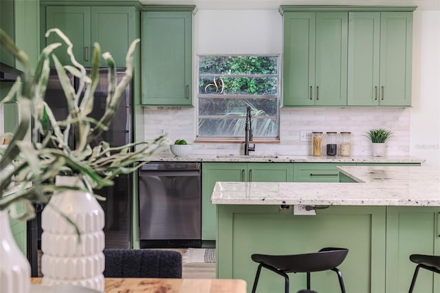 kitchen featuring decorative backsplash, green cabinetry, and dishwasher