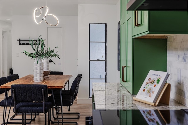 dining space with recessed lighting and wood finished floors