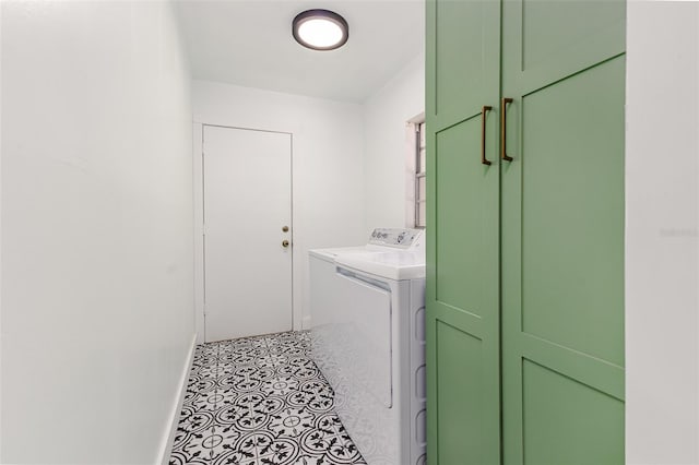 laundry area featuring laundry area, washing machine and dryer, and baseboards