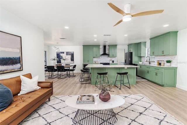 living room with light wood-style floors, recessed lighting, ceiling fan, and visible vents