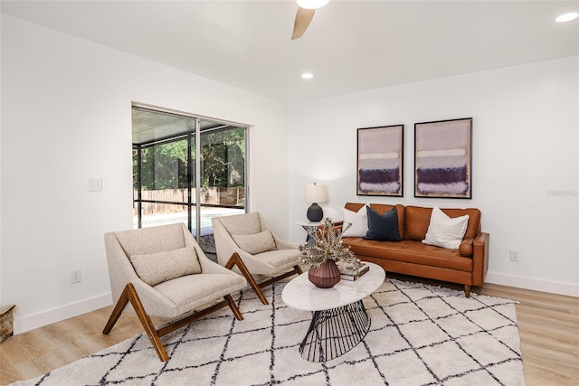 living room with light wood-style floors, baseboards, ceiling fan, and recessed lighting
