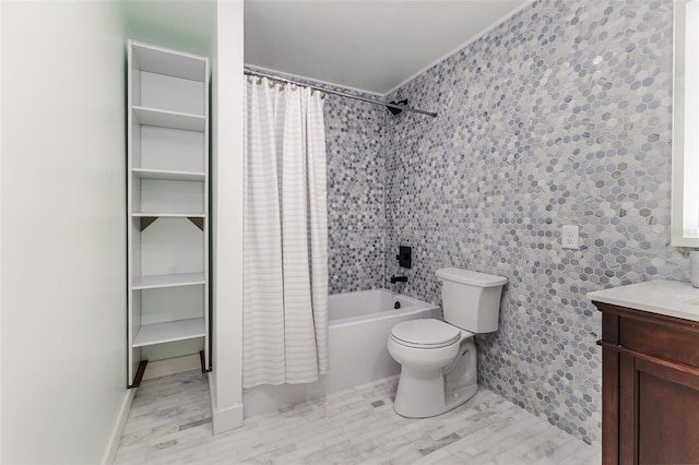 bathroom featuring vanity, toilet, tile walls, and shower / tub combo