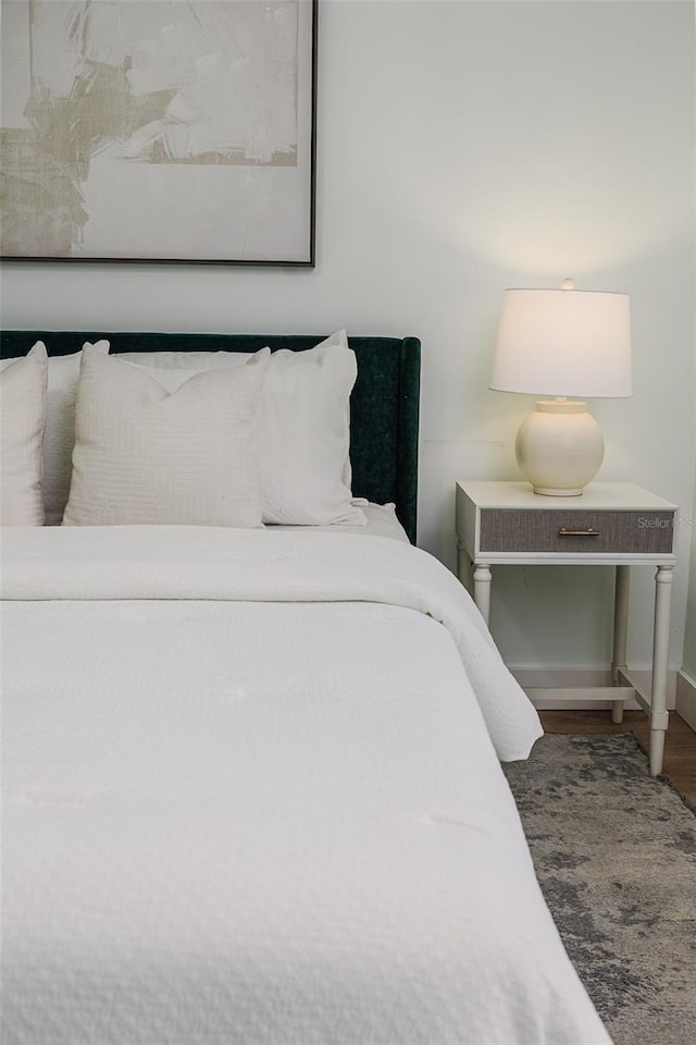 bedroom featuring baseboards and wood finished floors
