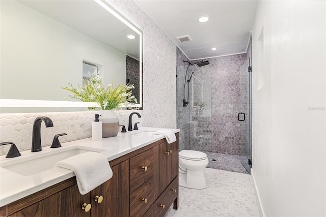 full bath featuring a sink, double vanity, toilet, visible vents, and a stall shower