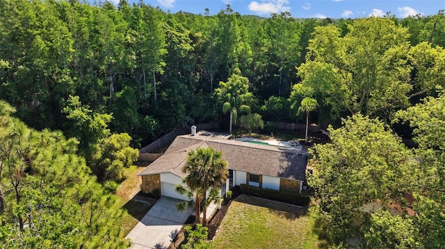 birds eye view of property featuring a view of trees