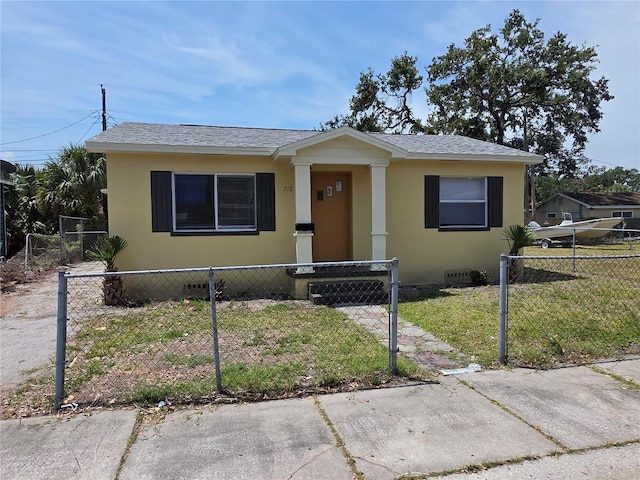 718 Paris Ave S, Saint Petersburg, FL 33701 - bungalow featuring roof with shingles, a fenced front yard, a front yard, and stucco siding