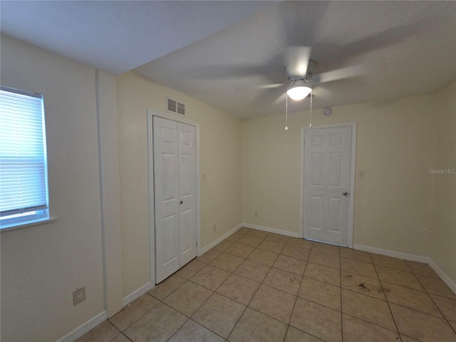 718 Paris Ave S, Saint Petersburg, FL 33701 - spare room featuring a healthy amount of sunlight, a ceiling fan, light tile patterned flooring, and visible vents