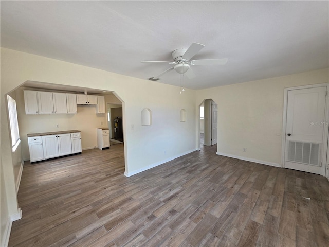 718 Paris Ave S, Saint Petersburg, FL 33701 - unfurnished living room featuring arched walkways, a ceiling fan, visible vents, and wood finished floors