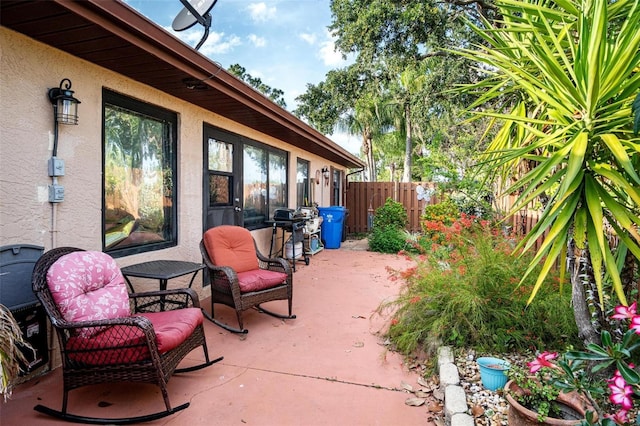 view of patio with fence and area for grilling