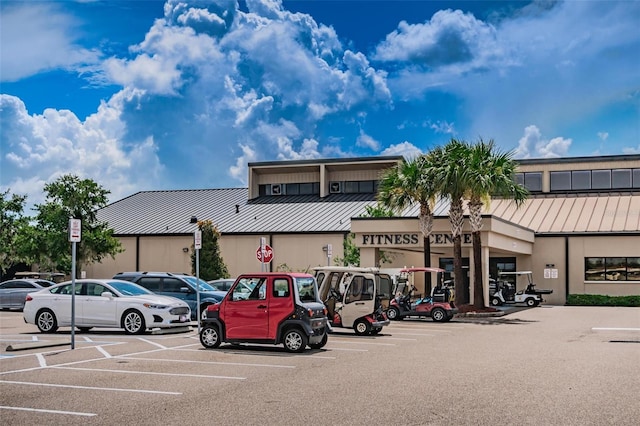 view of building exterior featuring uncovered parking