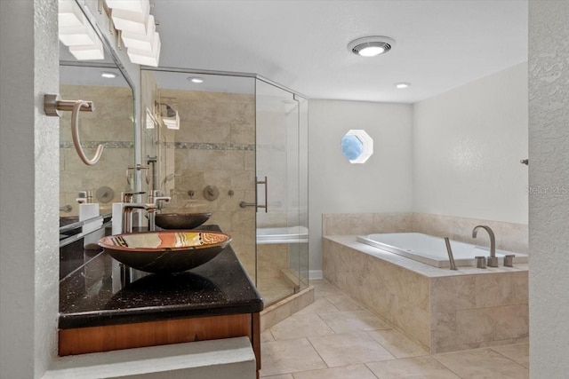 4531 44th St S, Saint Petersburg, FL 33711 - full bath featuring a garden tub, tile patterned flooring, double vanity, a sink, and a stall shower