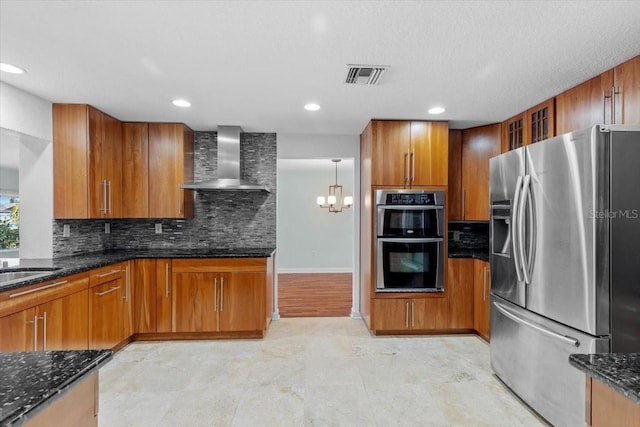 4531 44th St S, Saint Petersburg, FL 33711 - kitchen with wall chimney range hood, brown cabinetry, visible vents, tasteful backsplash, and stainless steel appliances