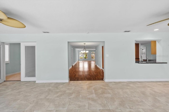 4531 44th St S, Saint Petersburg, FL 33711 - empty room featuring baseboards, visible vents, and ceiling fan with notable chandelier