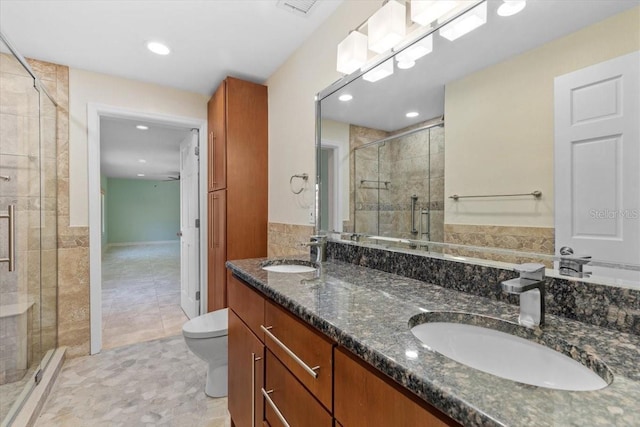 4531 44th St S, Saint Petersburg, FL 33711 - full bathroom with a sink, a shower stall, toilet, and double vanity