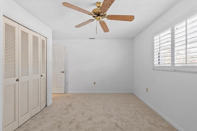4531 44th St S, Saint Petersburg, FL 33711 - unfurnished bedroom featuring baseboards, ceiling fan, carpet, and a closet
