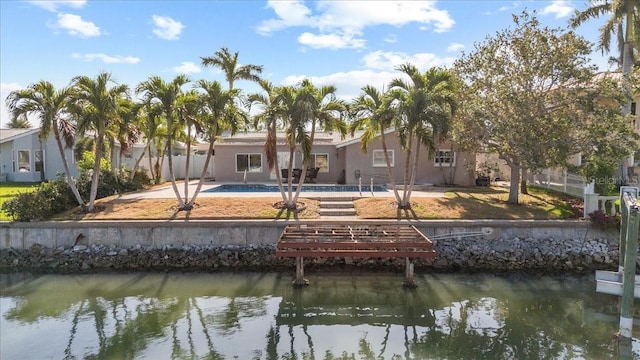 4531 44th St S, Saint Petersburg, FL 33711 - back of property with a water view, a fenced in pool, fence, and stucco siding
