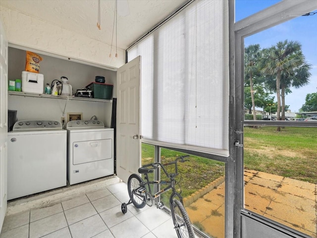 washroom with separate washer and dryer, laundry area, a healthy amount of sunlight, and light tile patterned floors
