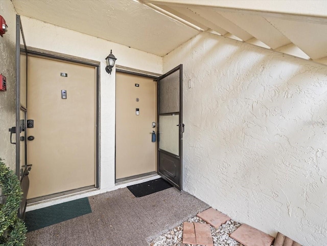 doorway to property with stucco siding