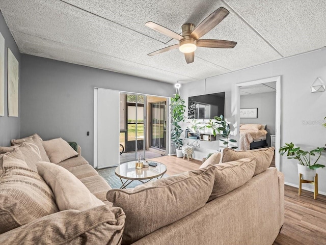 living room featuring ceiling fan and wood finished floors