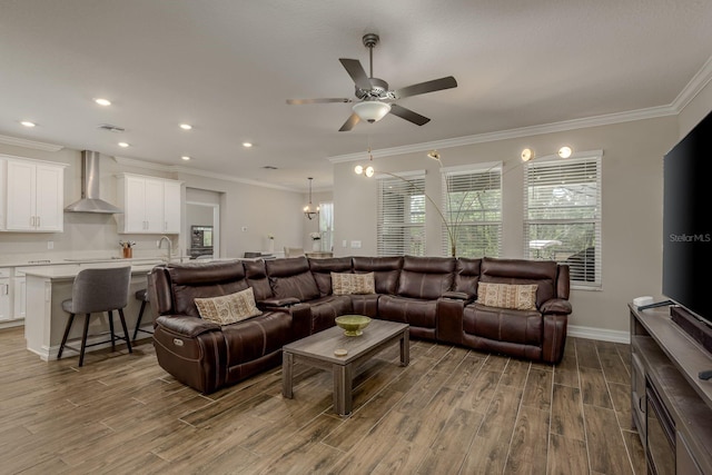 21590 Violet Periwinkle Dr, Land O Lakes, FL 34637 - living room featuring crown molding, a ceiling fan, recessed lighting, and wood finished floors