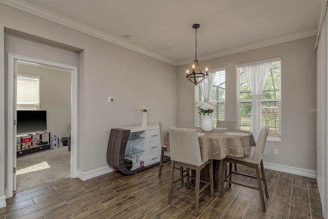 21590 Violet Periwinkle Dr, Land O Lakes, FL 34637 - dining space with baseboards, ornamental molding, wood finish floors, and a notable chandelier