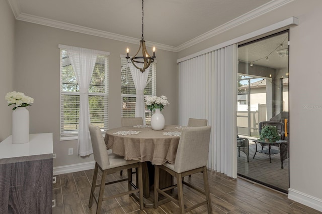 21590 Violet Periwinkle Dr, Land O Lakes, FL 34637 - dining area with an inviting chandelier, baseboards, crown molding, and dark wood-style floors