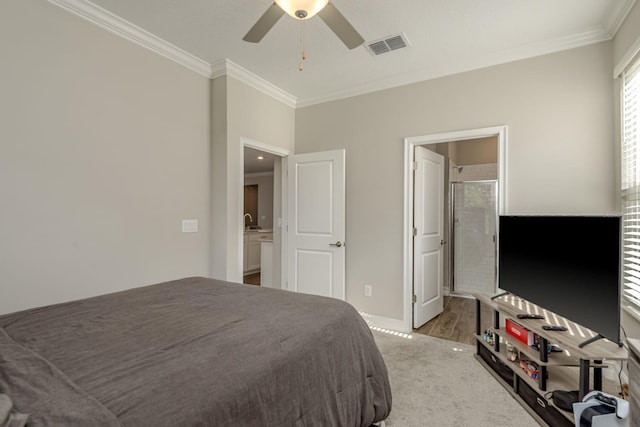 21590 Violet Periwinkle Dr, Land O Lakes, FL 34637 - bedroom featuring ceiling fan, visible vents, baseboards, ornamental molding, and ensuite bath