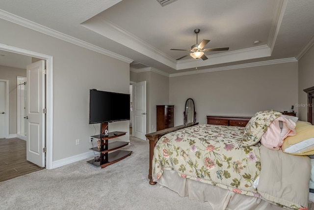 21590 Violet Periwinkle Dr, Land O Lakes, FL 34637 - bedroom with ceiling fan, a raised ceiling, baseboards, ornamental molding, and carpet flooring