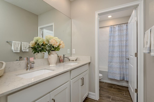 21590 Violet Periwinkle Dr, Land O Lakes, FL 34637 - full bath with double vanity, toilet, a sink, and wood finished floors