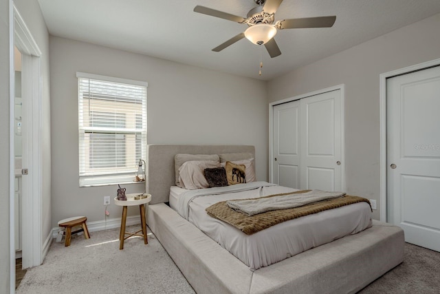 21590 Violet Periwinkle Dr, Land O Lakes, FL 34637 - bedroom with baseboards, multiple closets, light carpet, and ceiling fan