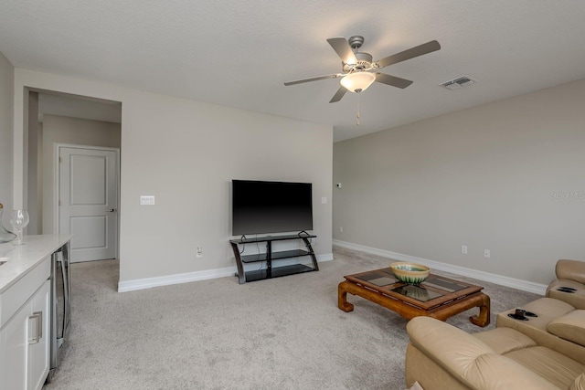 21590 Violet Periwinkle Dr, Land O Lakes, FL 34637 - living room featuring baseboards, light carpet, a ceiling fan, and visible vents