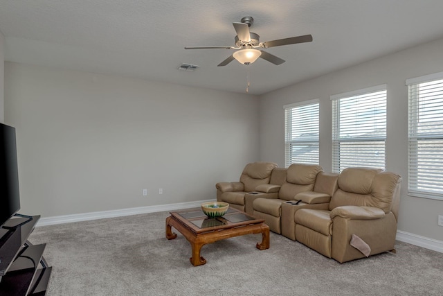 21590 Violet Periwinkle Dr, Land O Lakes, FL 34637 - carpeted living room featuring visible vents, a ceiling fan, and plenty of natural light