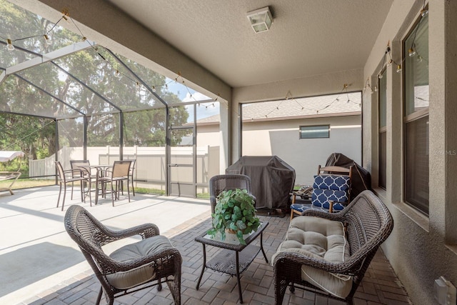 21590 Violet Periwinkle Dr, Land O Lakes, FL 34637 - view of patio / terrace with fence, glass enclosure, a grill, and outdoor dining space