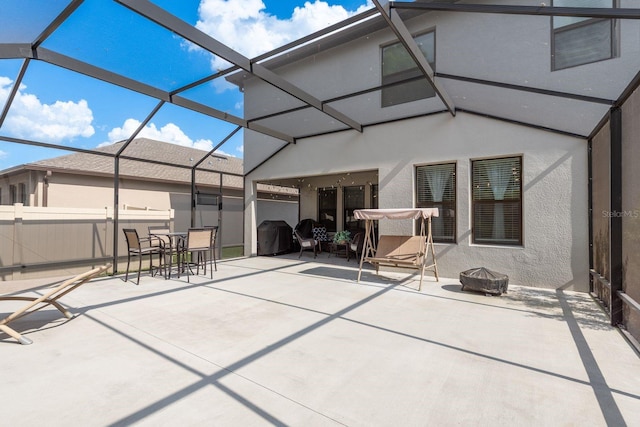 21590 Violet Periwinkle Dr, Land O Lakes, FL 34637 - rear view of property featuring stucco siding, a patio area, and an outdoor fire pit