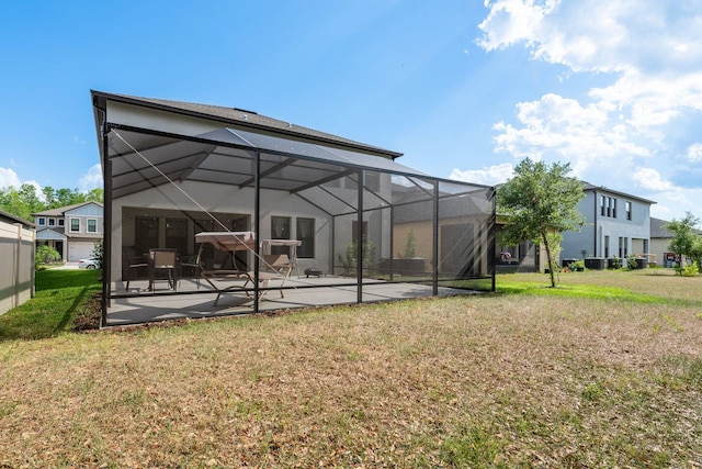 21590 Violet Periwinkle Dr, Land O Lakes, FL 34637 - back of property with a lawn, glass enclosure, and a patio area