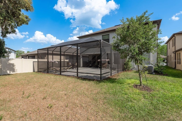 21590 Violet Periwinkle Dr, Land O Lakes, FL 34637 - rear view of house featuring fence, a patio area, central air condition unit, glass enclosure, and a yard