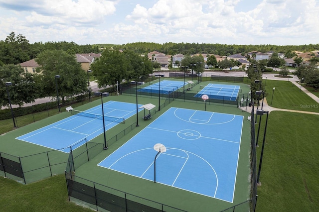 21590 Violet Periwinkle Dr, Land O Lakes, FL 34637 - view of basketball court featuring a lawn, a tennis court, fence, and community basketball court