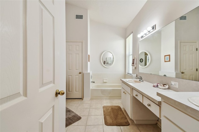 bathroom featuring double vanity, a garden tub, a sink, tile patterned floors, and visible vents