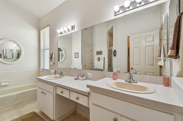 full bath with a garden tub, tile patterned flooring, and a sink