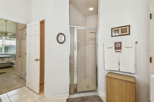 bathroom with lofted ceiling, baseboards, ensuite bath, a shower stall, and tile patterned flooring