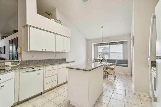 kitchen with white dishwasher, pendant lighting, light tile patterned floors, white cabinetry, and a kitchen island
