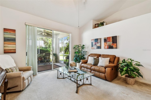 living area featuring ceiling fan, lofted ceiling, carpet floors, and baseboards