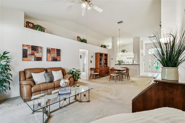 living area featuring a ceiling fan, carpet flooring, visible vents, and high vaulted ceiling