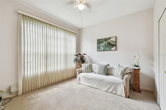 living area with ceiling fan and carpet floors