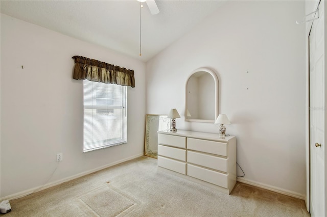 bedroom with light colored carpet, baseboards, and lofted ceiling