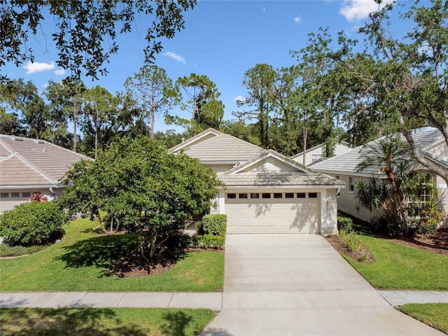 view of front of home featuring a front lawn, a tiled roof, driveway, and a garage