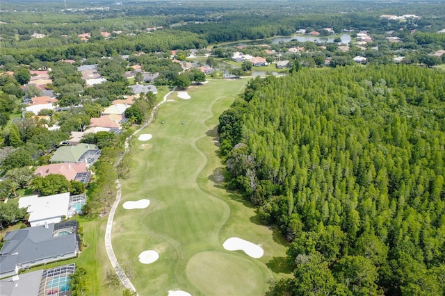 drone / aerial view featuring view of golf course and a residential view