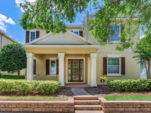 view of front of house featuring a porch and stucco siding