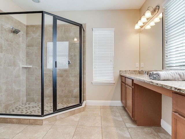 bathroom featuring baseboards, tile patterned flooring, vanity, and a shower stall